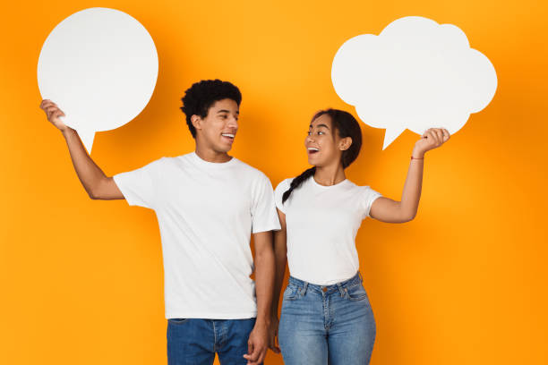 istock Speech bubbles. Teenage couple with blank placards 1152823909