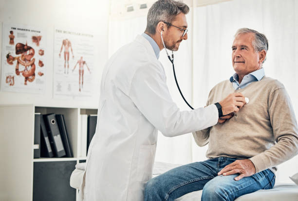 Heart health is especially important in seniors Shot of a doctor checking his mature patient's heart during a consultation in a medical center listening to heartbeat stock pictures, royalty-free photos & images