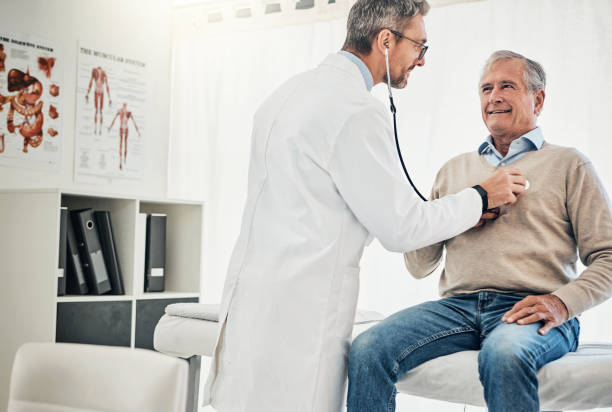Let's hear what your heart has to say Shot of a doctor checking his mature patient's heart during a consultation in a medical center clinic men healthcare and medicine doctor stock pictures, royalty-free photos & images