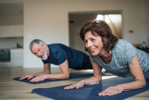 istock A senior couple indoors at home, doing exercise on the floor. 1152830259