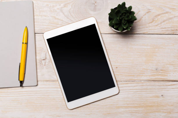 istock White digital tablet on wooden table. Flat lay. 1152830301