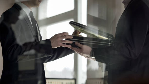istock Businessman checking dollars in briefcase, kickback in illegal cooperation 1152830451
