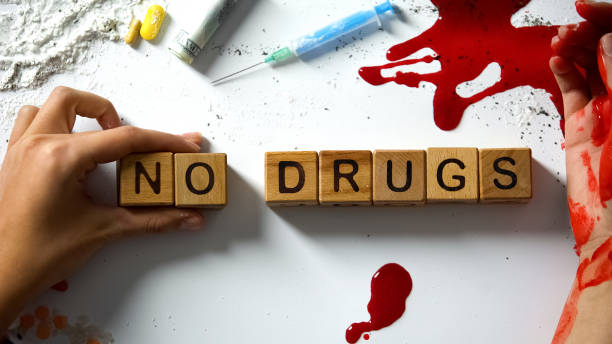 no drugs words on wooden cubes, bleeding hand and narcotics on table, concept - photography sign table ganja imagens e fotografias de stock