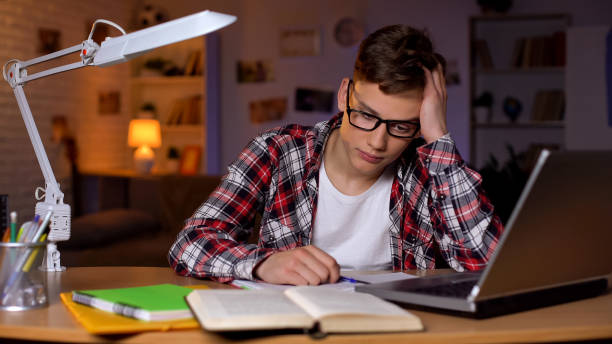istock Overloaded student trying to do assignment, feeling confused, project deadline 1152831210