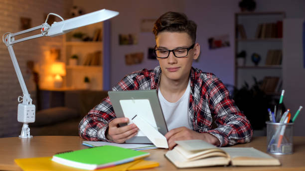istock Student looking at family photo missing parents, studying far from home, college 1152831292