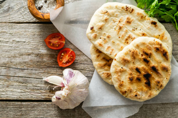 istock Traditional pita bread on rustic wood background 1152832567