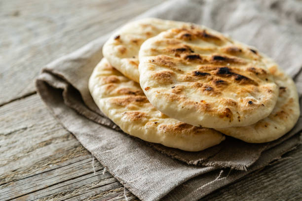 Traditional pita bread on rustic wood background stock photo