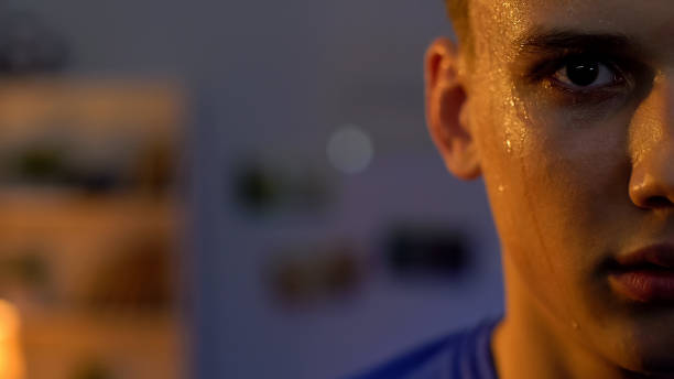 istock Serious young man looking into camera after intensive workout in gym, half-face 1152832598