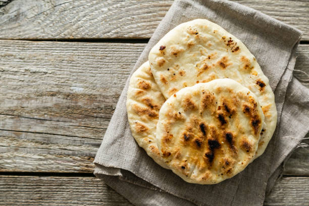 istock Traditional pita bread on rustic wood background 1152832636