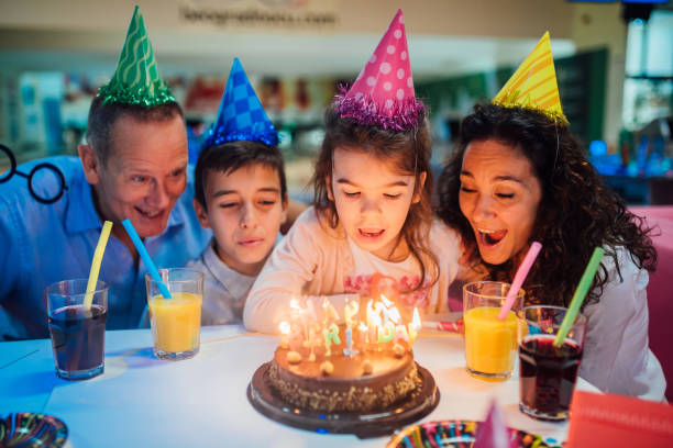 istock Young children blowing birthday candles 1152833314