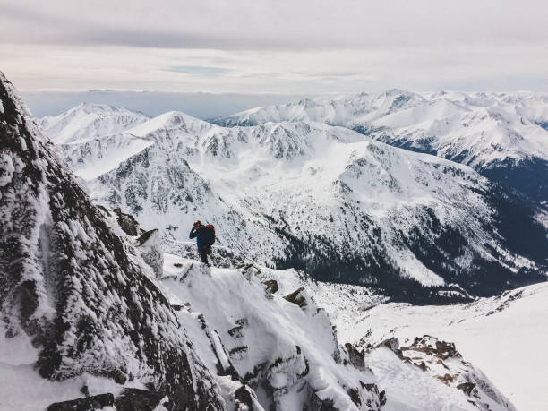 istock Winter mountain adventure. Man on a trail 1152834590