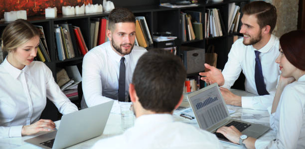 istock Team of business people having discussion at table in creative office. 1152834752
