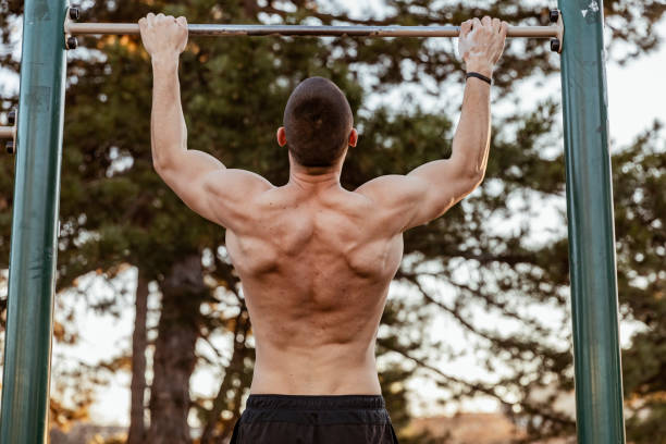 istock Handsome Young Athlete Doing Chin-ups on Horizontal Bar 1152836640