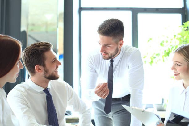 istock Group of business partners discussing ideas and planning work in office. 1152836651