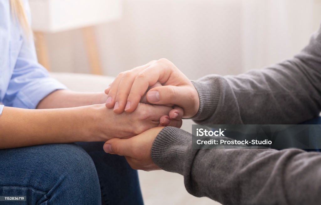 Psychiatrist councelling his patient hands during therapy Compassion and concern concept. Psychiatrist supporting his patient hands during therapy Psychotherapy Stock Photo Psychiatrist councelling his patient hands during therapy Compassion and concern concept. Psychiatrist supporting his patient hands during therapy Psychotherapy Stock Photo