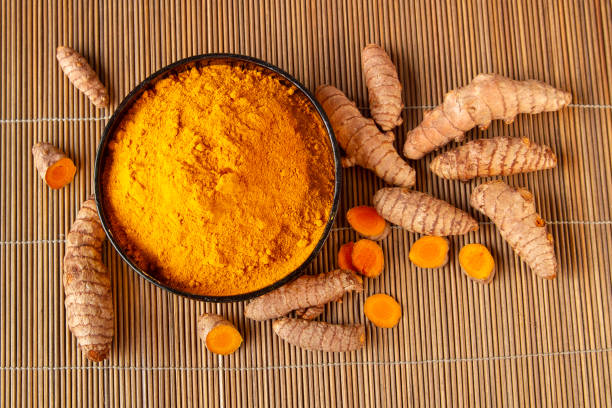 istock turmeric roots and powder on bamboo napkin top view 1152836796