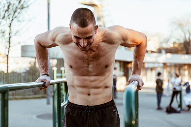 istock Young Muscular Athlete is Exercising On Horizontal Bars 1152836876