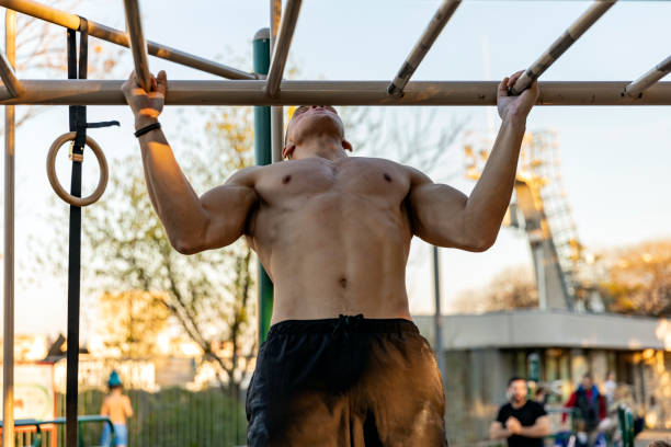 istock Muscular Athlete Exercising On Monkey Bars 1152836909