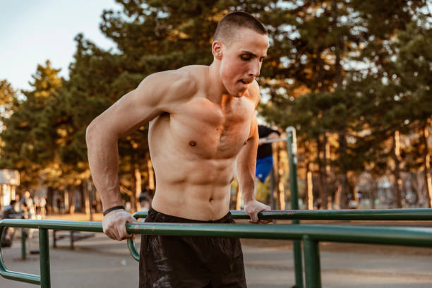 istock Young Muscular Athlete is Exercising On Horizontal Bars 1152836916