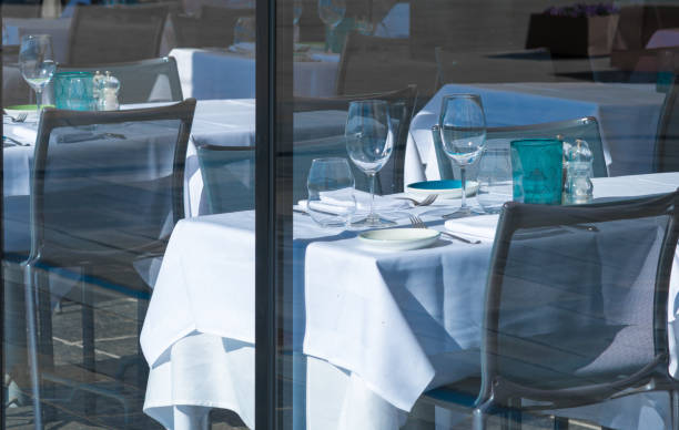 istock Window of a restaurant with tables and dishes 1152838115