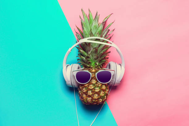 istock pineapple on colored paper with glasses 1152840324
