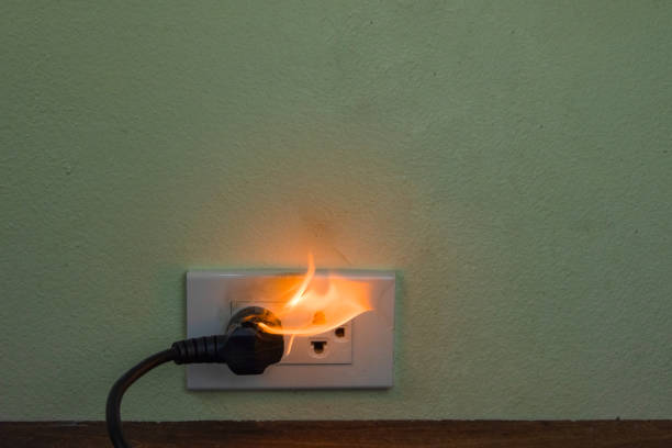 istock On fire electric wire plug Receptacle wall partition,Electric short circuit failure resulting in electricity wire burnt 1152840940