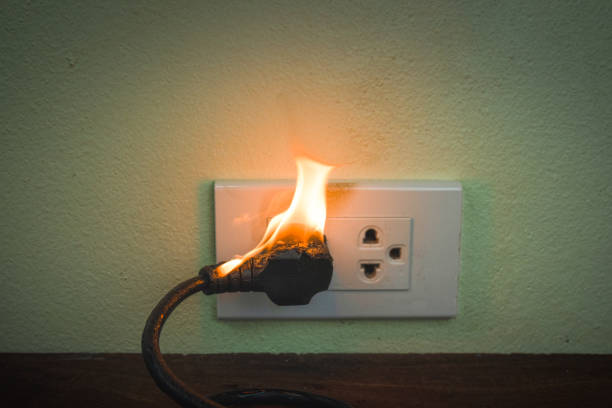istock On fire electric wire plug Receptacle wall partition,Electric short circuit failure resulting in electricity wire burnt 1152840941