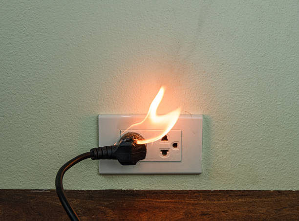 istock On fire electric wire plug Receptacle wall partition,Electric short circuit failure resulting in electricity wire burnt 1152840942