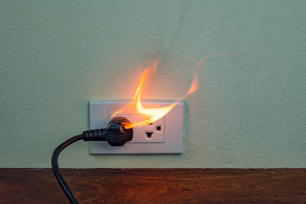 istock On fire electric wire plug Receptacle wall partition,Electric short circuit failure resulting in electricity wire burnt 1152840943