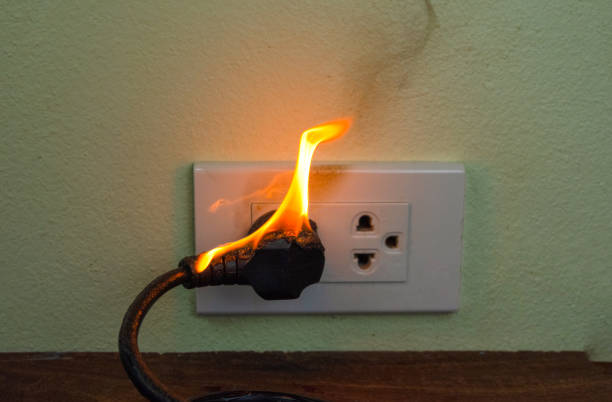 istock On fire electric wire plug Receptacle wall partition,Electric short circuit failure resulting in electricity wire burnt 1152840972