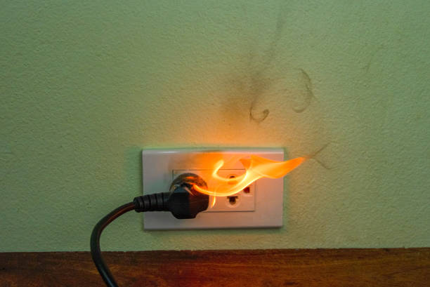 istock On fire electric wire plug Receptacle wall partition,Electric short circuit failure resulting in electricity wire burnt 1152840973