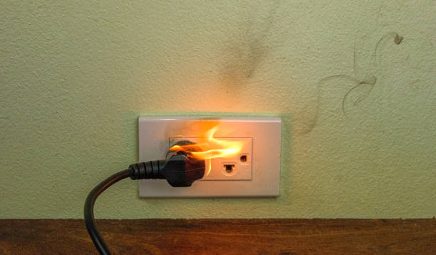 istock On fire electric wire plug Receptacle wall partition,Electric short circuit failure resulting in electricity wire burnt 1152840998
