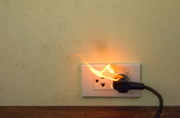 istock On fire electric wire plug Receptacle wall partition,Electric short circuit failure resulting in electricity wire burnt 1152840999