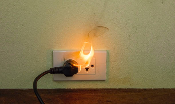 istock On fire electric wire plug Receptacle wall partition,Electric short circuit failure resulting in electricity wire burnt 1152841000