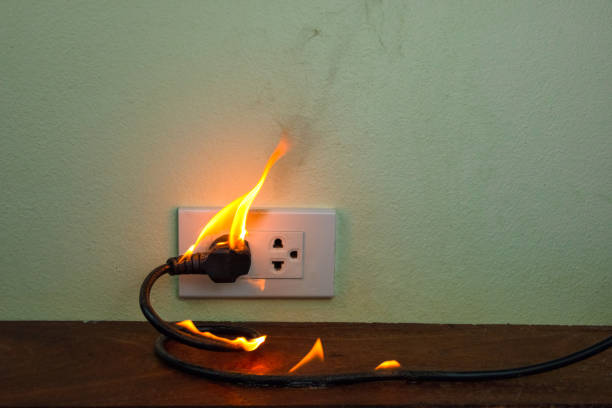 istock On fire electric wire plug Receptacle wall partition,Electric short circuit failure resulting in electricity wire burnt 1152841016