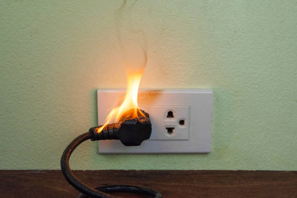 istock On fire electric wire plug Receptacle wall partition,Electric short circuit failure resulting in electricity wire burnt 1152841018