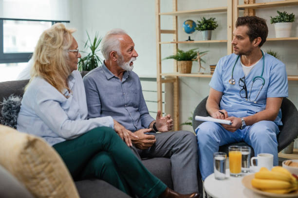 istock Senior man explaining his health problems to a doctor during home visit. 1152845449