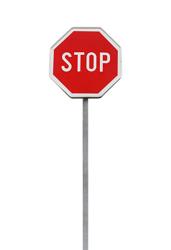 Stop. Red road sign on metal pole isolated on white background