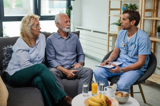 istock General practitioner talking to senior patients while visiting them at home. 1152846487