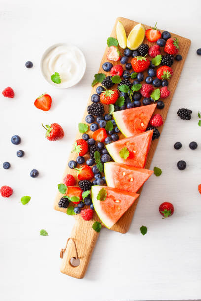 istock fruit and berry platter over white. blueberry, strawberry, raspberry, blackberry, watermelon 1152846636