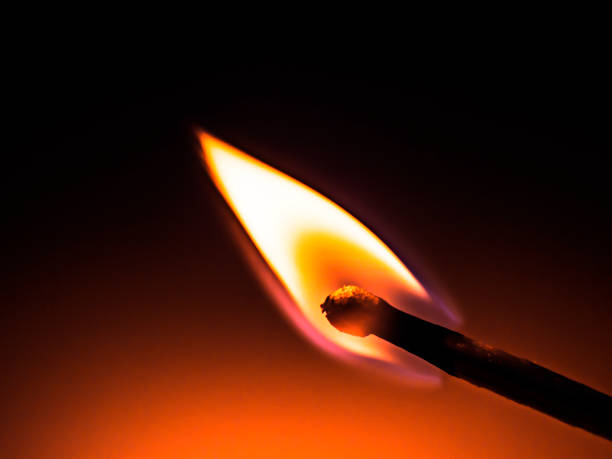 istock flame of a burning match on a dark background 1152847046
