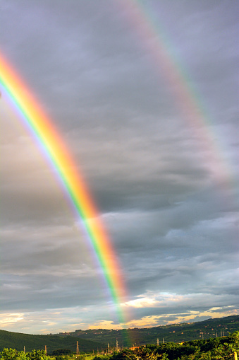 Double rainbow landscape in beautiful landscape scenery taken on sunny and rainy day.