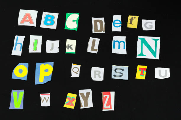 istock Colorful newspaper alphabet isolated on black 1152848257