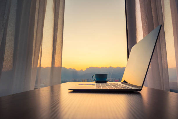 istock Laptop on wood table by window 1152850158