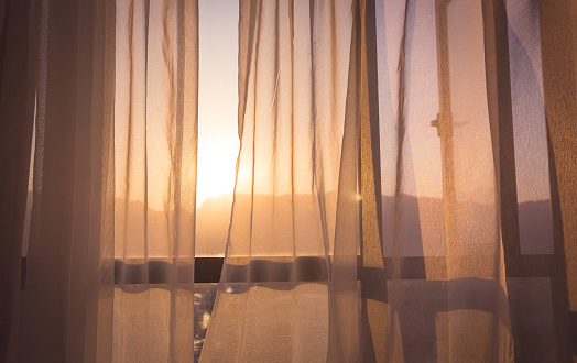Curtain at the window of room in the morning