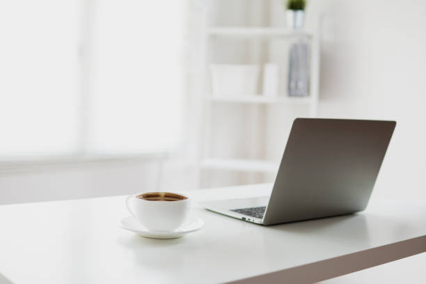 istock white and clear office room with laptop and coffee on table 1152850266