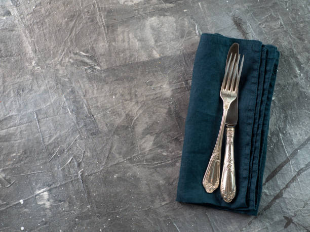 istock Cutlery on emerald linen napkin, copy space 1152850391