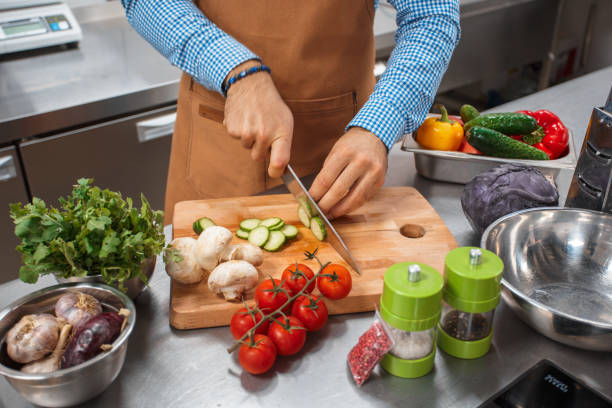 istock The chef in brown apron cooking in a restaurant kitchen 1152851138