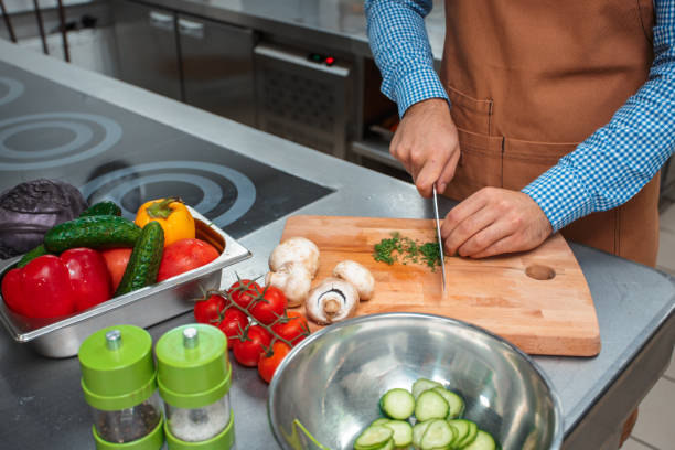 istock The chef in brown apron cooking in a restaurant kitchen 1152851697