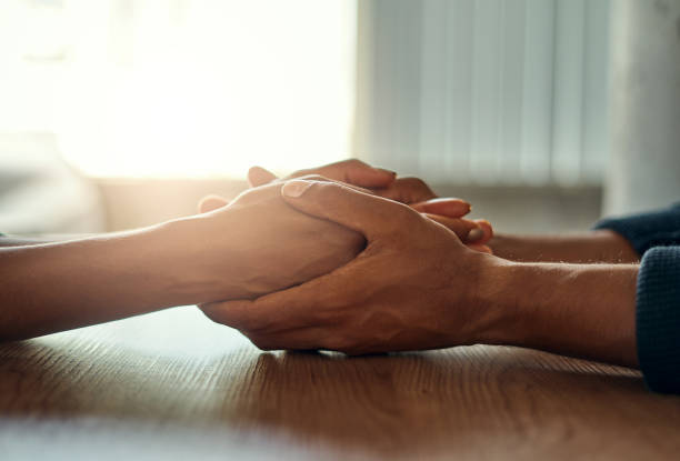 istock Couple holding their hands on desk 1152852994